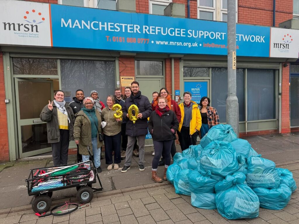 Afzal Khan standing with the number 30 with other volunteers in front of MRSN